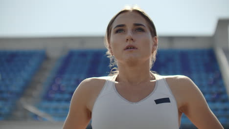 A-time-lapse-portrait-of-beautiful-woman-running-on-the-stadium-bleachers-with-concentrated-deep-breathing-and-motivating-myself-and-consciousness-for-the-race.-Discard-unnecessary-emotions-and-tune-in-to-win-preparing-for-the-race
